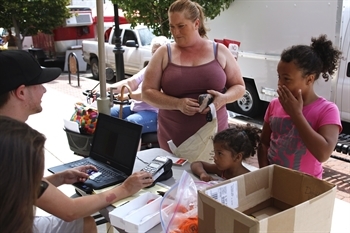 people buying products at farmer's market 