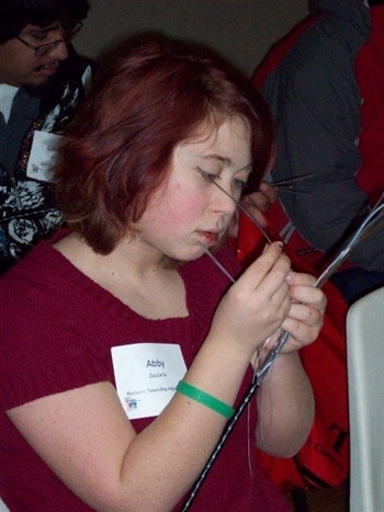 Abby Zaccaria looking at fiber optic cable